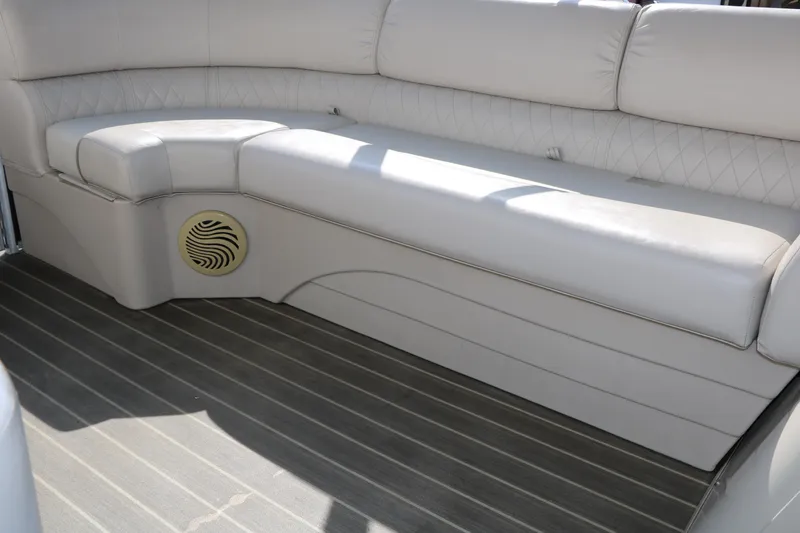 Slide: The Image of 2015 Bennington 21 SLX boat interior with beige seating and speaker detail. - 36