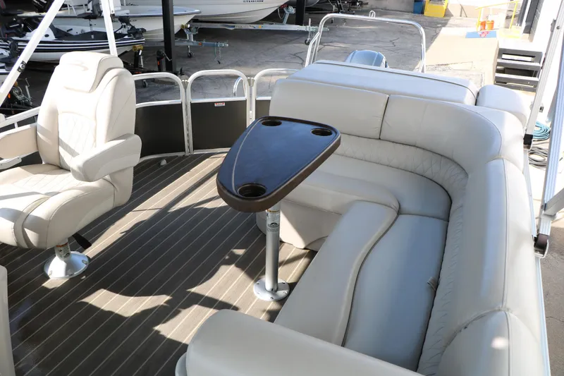 Slide: The Image of 2015 Bennington 21 SLX pontoon boat interior with plush seating and table. - 38