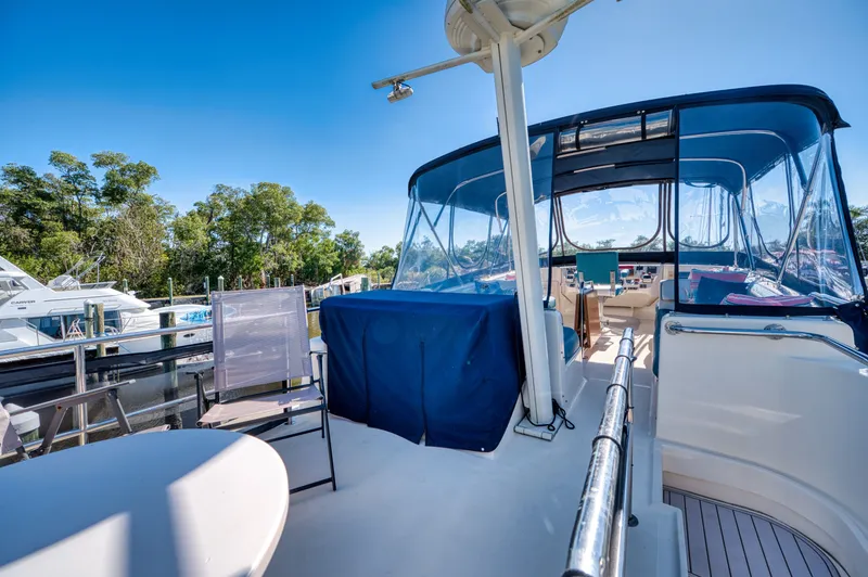 Slide: The Image of 2005 Mainship 400 Trawler on sunny deck with blue cover. - 10