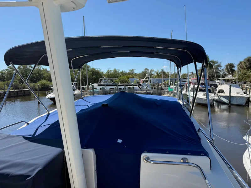 Slide: The Image of 2005 Mainship 400 Trawler docked with blue cover. - 11