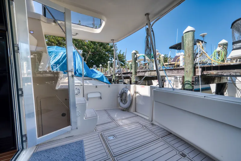 Slide: The Image of Mainship 400 Trawler 2005, spacious deck, marina scene. - 13