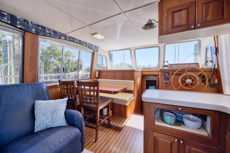 Slide: The Image of Interior of a 2005 Mainship 400 Trawler with wooden furnishings. - 16