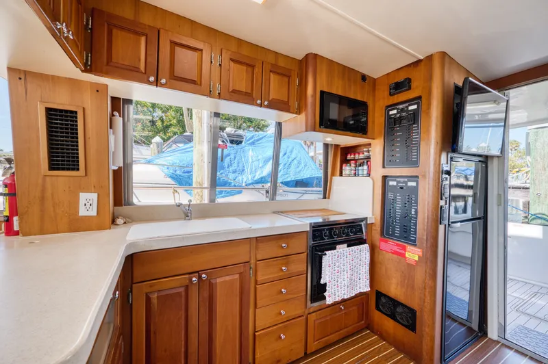 Slide: The Image of Mainship 400 Trawler 2005 kitchen with wooden cabinets and appliances. - 17