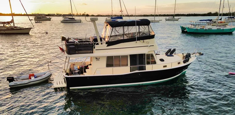 Slide: The Image of 2005 Mainship 400 Trawler on water at sunset. - 2