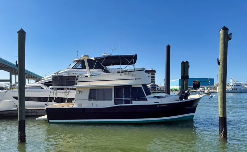 Slide: The Image of 2005 Mainship 400 Trawler docked in harbor under clear sky. - 3