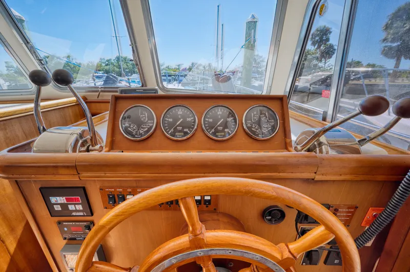 Slide: The Image of Helm of a 2005 Mainship 400 Trawler with wooden finish. - 31