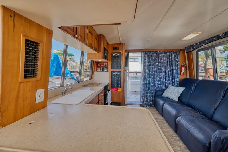 Slide: The Image of Interior of 2005 Mainship 400 Trawler with kitchen and sofa. - 33