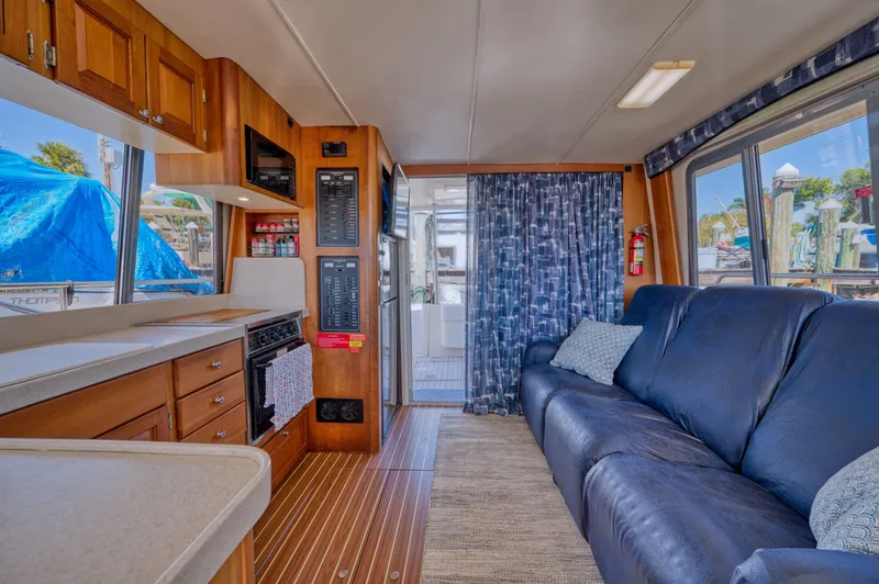 Slide: The Image of Interior of a 2005 Mainship 400 Trawler with sofa and kitchen. - 34