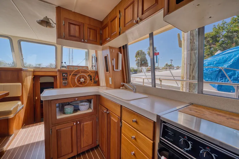 Slide: The Image of Interior of 2005 Mainship 400 Trawler with wooden kitchen. - 35