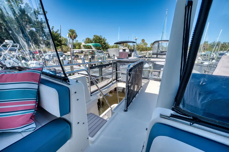 Slide: The Image of 2005 Mainship 400 Trawler in sunny marina setting. - 39