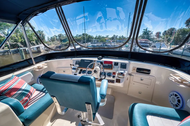 Slide: The Image of Interior view of 2005 Mainship 400 Trawler helm with blue seats. - 40