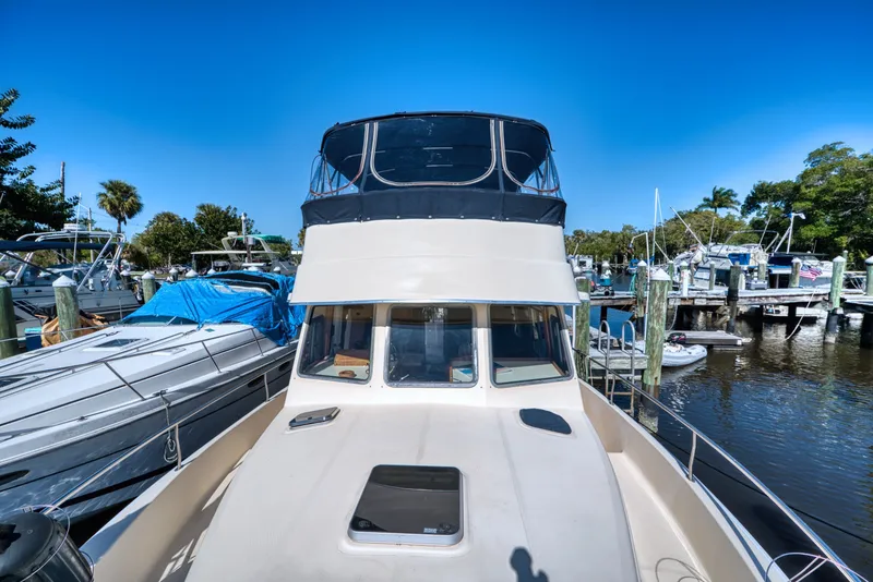 Slide: The Image of 2005 Mainship 400 Trawler docked on a sunny day. - 5