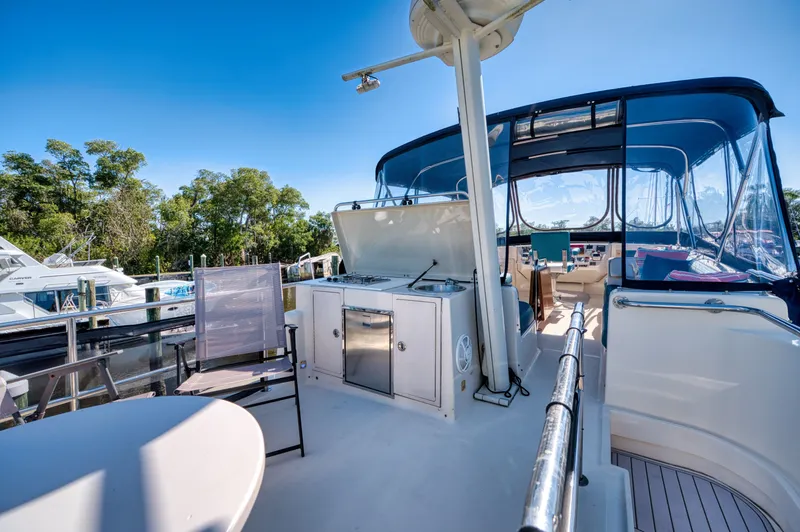 Slide: The Image of 2005 Mainship 400 Trawler with spacious deck and seating area. - 8