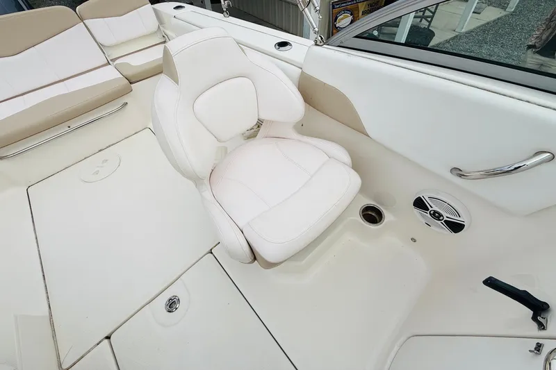 Slide: The Image of 2019 Robalo R207 Dual Console boat interior with white seating and speaker. - 6