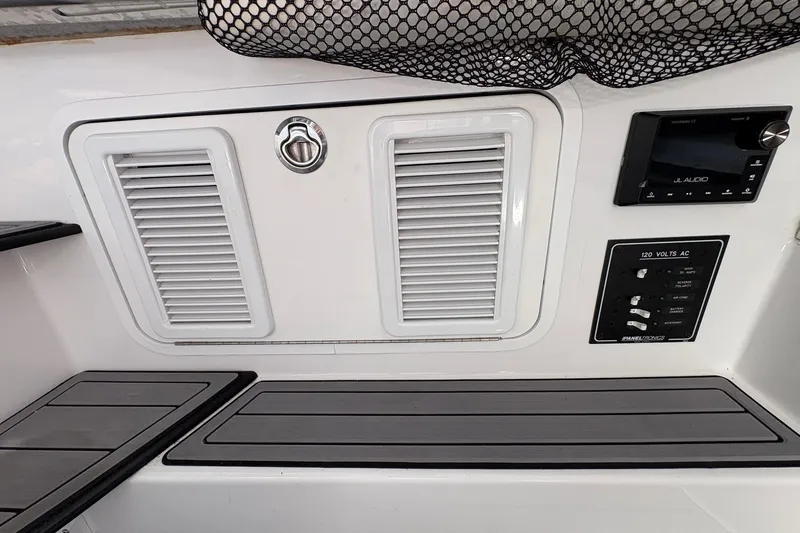 Slide: The Image of 2023 Nor-Tech 390 Sport Center Console dashboard with JL Audio system and control panel. - 18