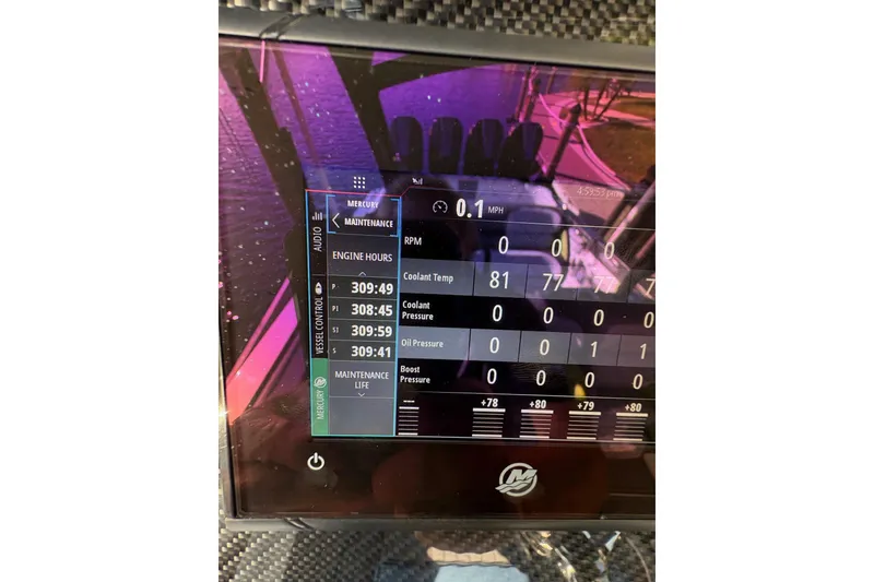 Slide: The Image of Display screen of 2023 Nor-Tech 390 Sport Center Console showing engine metrics. - 19