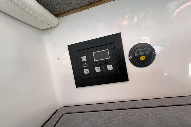 Slide: The Image of Control panel on 2023 Nor-Tech 390 Sport Center Console boat interior. - 23