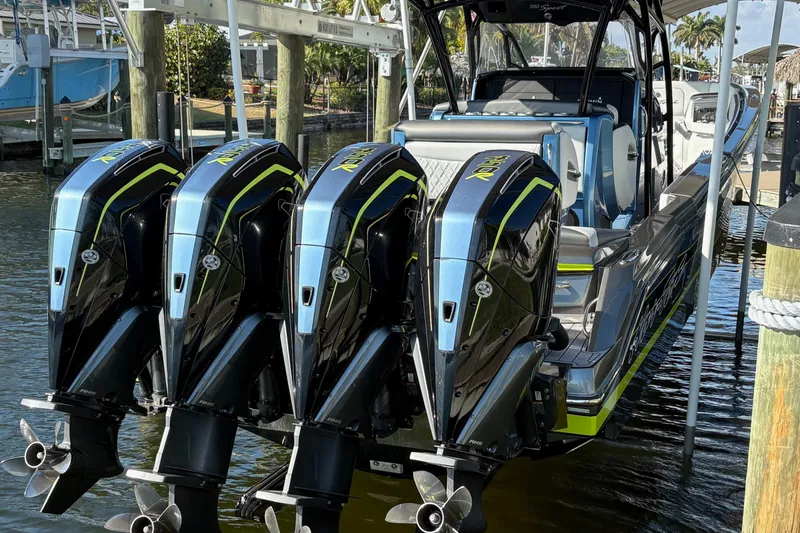 Slide: The Image of 2023 Nor-Tech 390 Sport Center Console with four powerful outboard engines docked. - 5