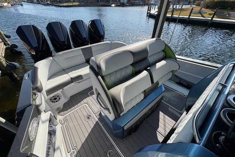 Slide: The Image of 2023 Nor-Tech 390 Sport Center Console boat interior with luxurious seating and powerful engines. - 9