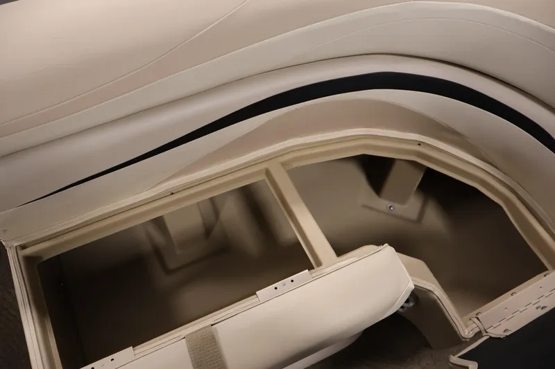 Slide: The Image of 2012 Bennington 2275 GCW boat storage compartment with beige upholstery. - 14