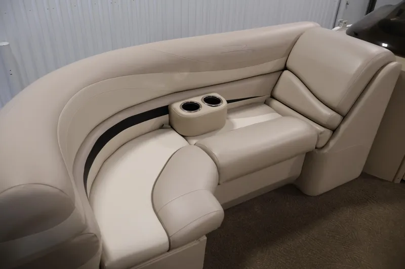 Slide: The Image of 2012 Bennington 2275 GCW boat interior seating with cup holders, beige upholstery. - 15