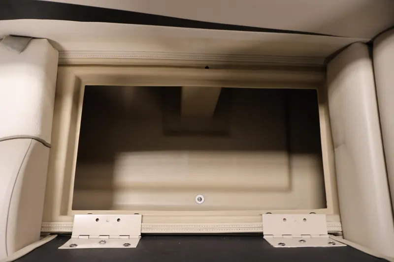 Slide: The Image of Storage compartment in 2012 Bennington 2275 GCW boat, featuring beige interior and sturdy hinges. - 18