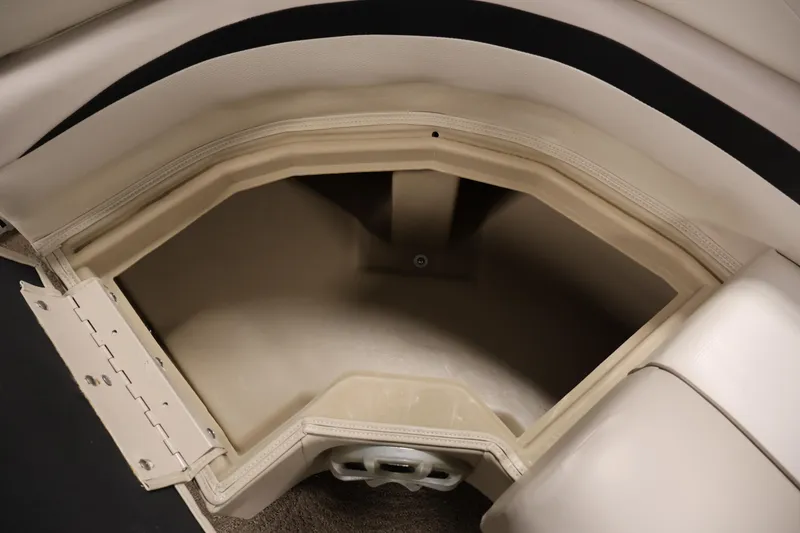 Slide: The Image of Storage compartment in 2012 Bennington 2275 GCW boat, featuring beige interior and cushioned seating. - 19