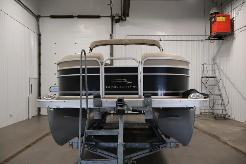 Slide: The Image of 2012 Bennington 2275 GCW pontoon boat in indoor storage on trailer. - 2