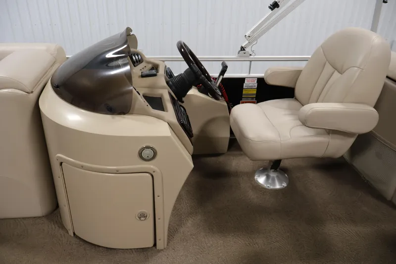 Slide: The Image of 2012 Bennington 2275 GCW boat interior with steering console and captain's chair. - 20