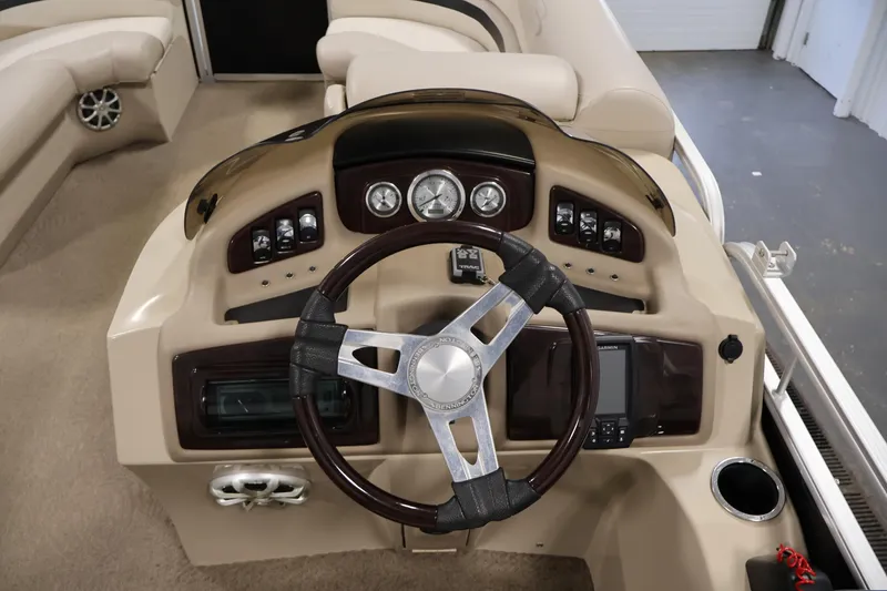 Slide: The Image of 2012 Bennington 2275 GCW boat dashboard with steering wheel and control panel. - 22