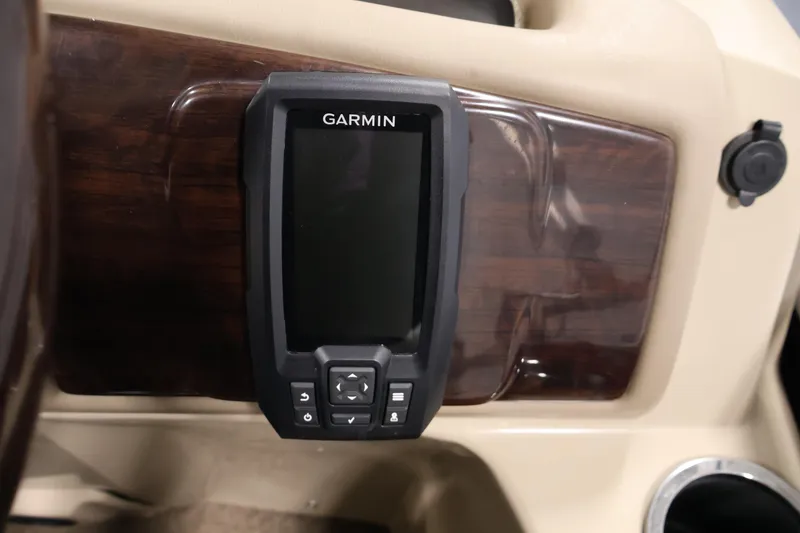 Slide: The Image of Garmin device on 2012 Bennington 2275 GCW dashboard with wood paneling. - 28