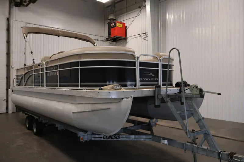 Slide: The Image of 2012 Bennington 2275 GCW pontoon boat on trailer in indoor storage. - 3