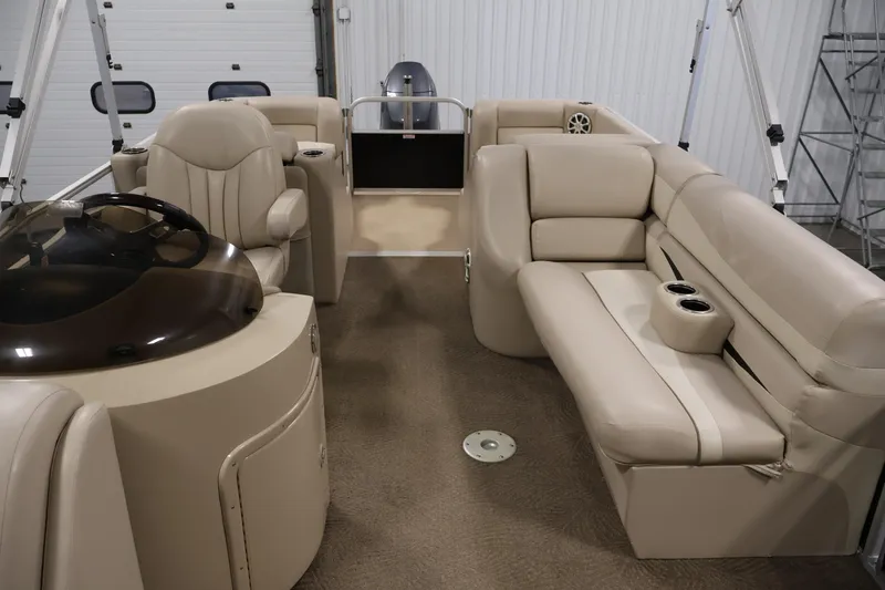 Slide: The Image of 2012 Bennington 2275 GCW boat interior with beige seating and helm station. - 33