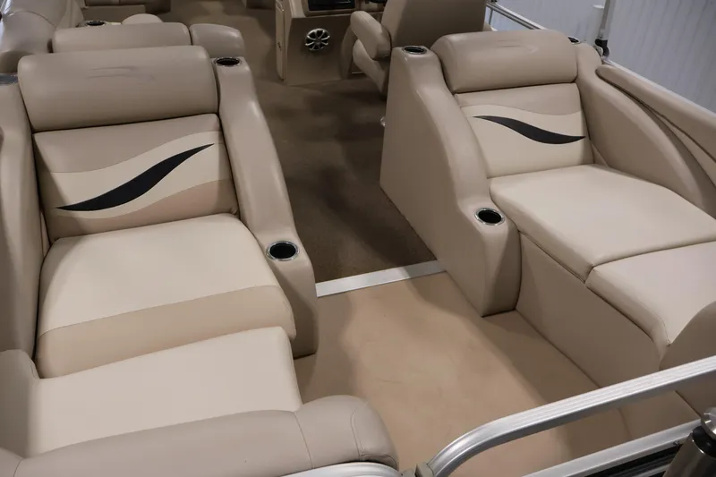 Slide: The Image of 2012 Bennington 2275 GCW boat interior with beige seating and cup holders. - 36