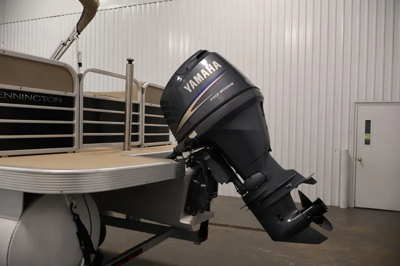 Slide: The Image of 2012 Bennington 2275 GCW pontoon boat with Yamaha outboard motor in a garage. - 40