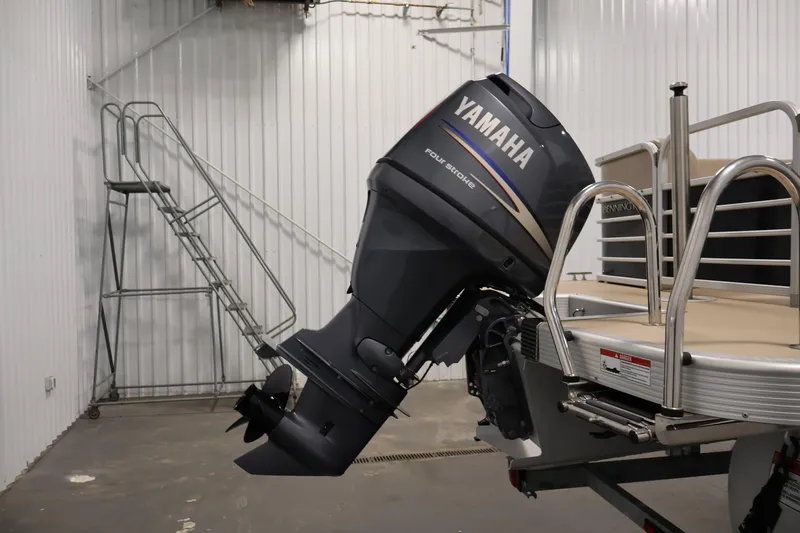 Slide: The Image of 2012 Bennington 2275 GCW pontoon boat with Yamaha four-stroke outboard motor in a storage facility. - 41