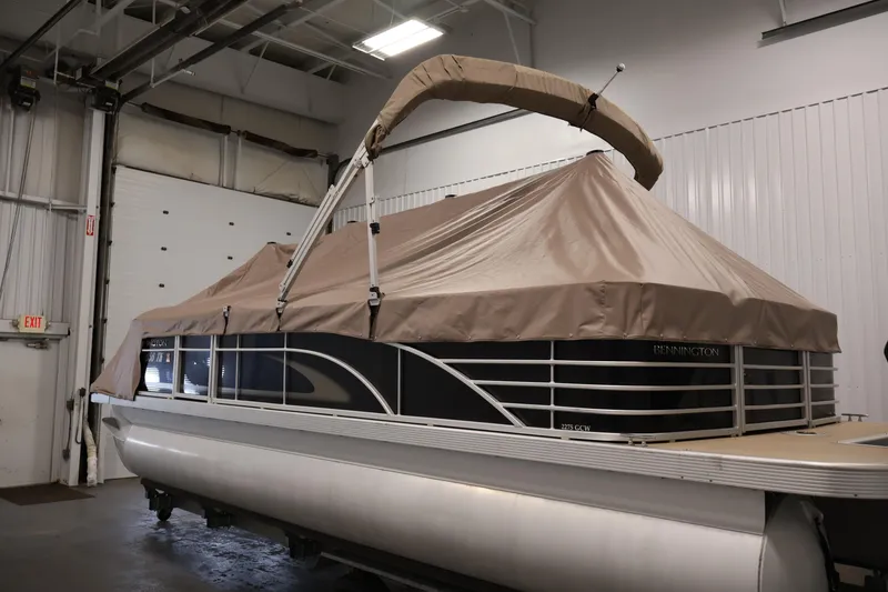 Slide: The Image of 2012 Bennington 2275 GCW pontoon boat with cover in indoor storage. - 46