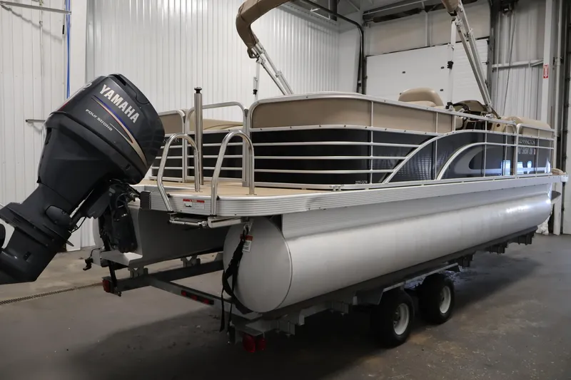 Slide: The Image of 2012 Bennington 2275 GCW pontoon boat with Yamaha outboard motor in a garage. - 5