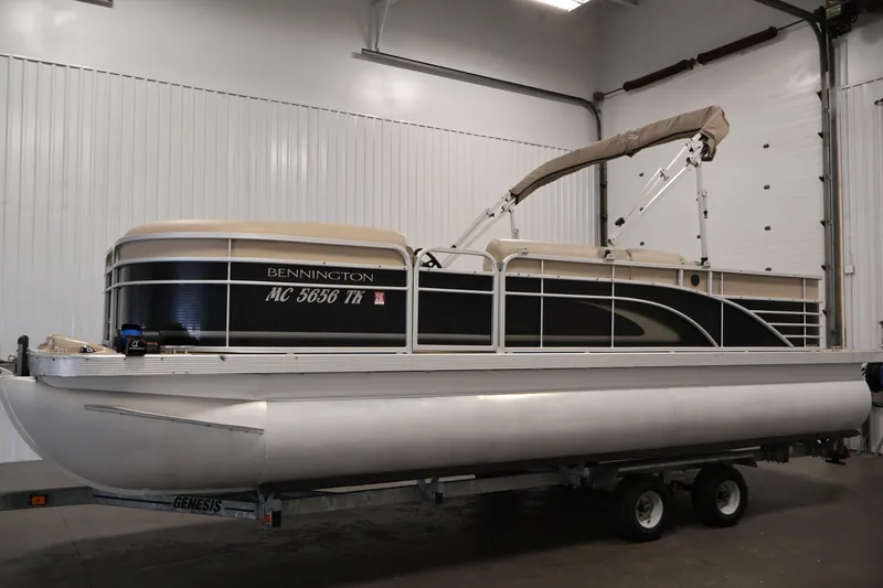Slide: The Image of 2012 Bennington 2275 GCW pontoon boat on trailer in indoor storage. - 8