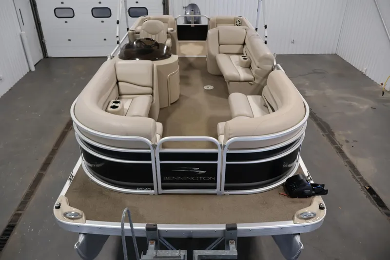 Slide: The Image of 2012 Bennington 2275 GCW pontoon boat with beige seating in a garage setting. - 9