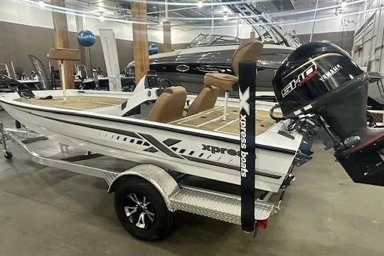 Slide: The Image of 2026 Xpress H18 boat with Yamaha engine on display in showroom. - 13