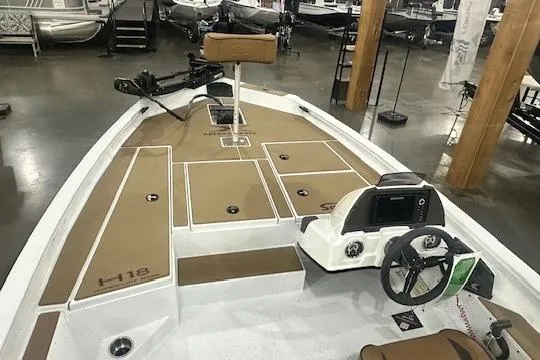 Slide: The Image of 2026 Xpress H18 boat interior with steering wheel and seating, displayed in showroom. - 15