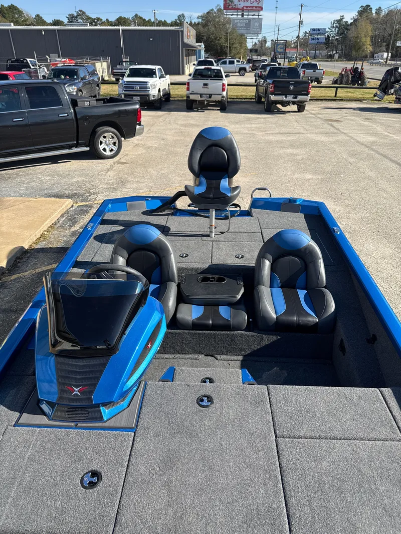 Slide: The Image of 2025 Vexus AVX1880 boat with blue and black seats on parking lot. - 25