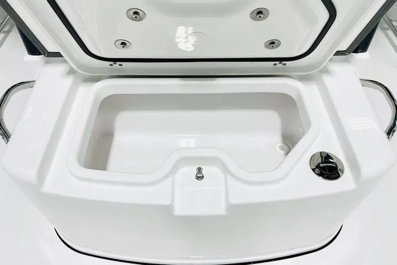 Slide: The Image of 2026 Sportsman Open 262 Center Console storage compartment, open lid, white interior, stainless steel accents. - 14