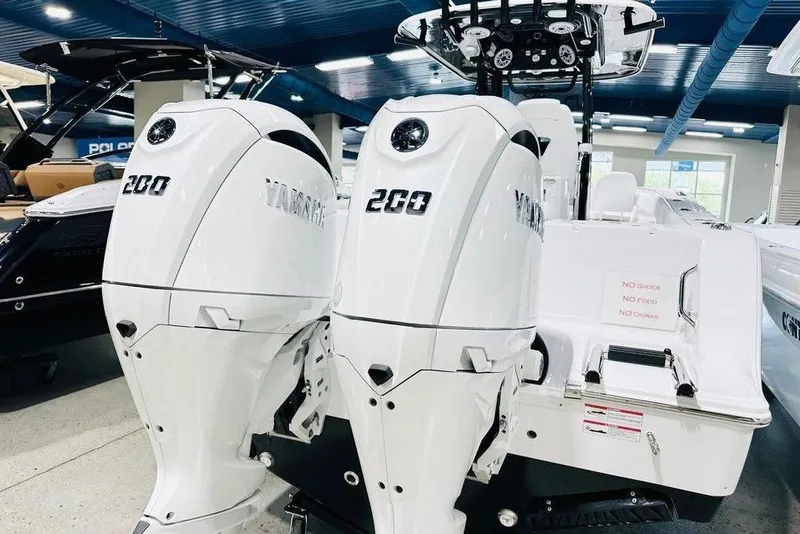 Slide: The Image of 2026 Sportsman Open 262 Center Console with twin Yamaha 200 engines in showroom. - 15