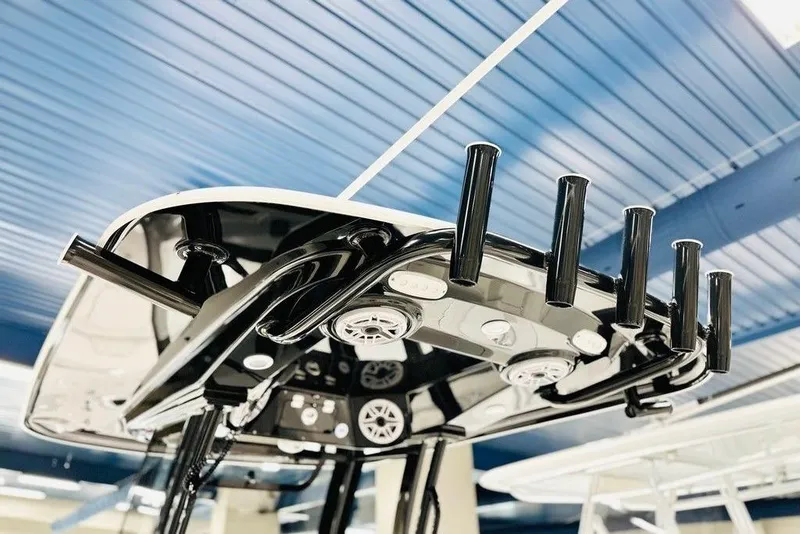 Slide: The Image of 2026 Sportsman Open 262 Center Console boat with sleek black rod holders and modern design. - 2