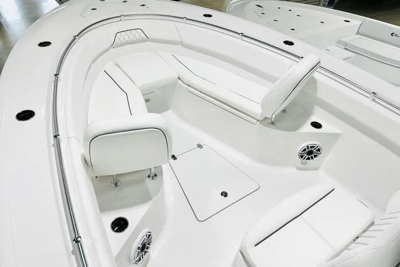 Slide: The Image of 2026 Sportsman Open 262 Center Console boat interior with white seating and speakers. - 6