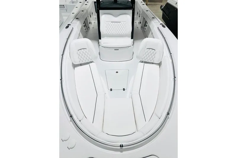 Slide: The Image of 2026 Sportsman Open 262 Center Console boat interior with white cushioned seating. - 7