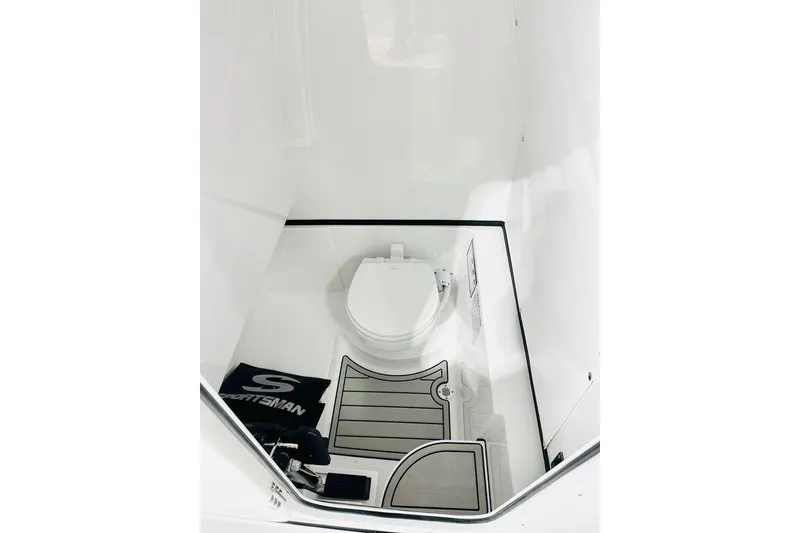 Slide: The Image of 2026 Sportsman Open 262 Center Console boat interior with toilet and mat. - 8