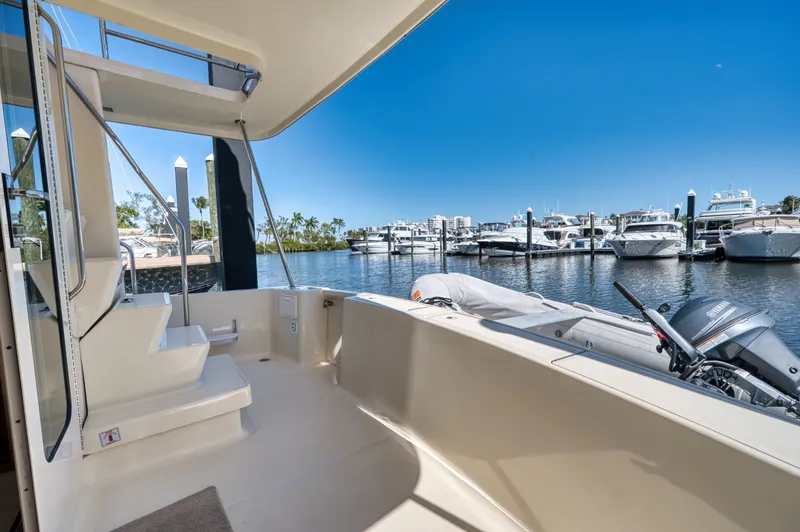 Slide: The Image of 2006 Mainship 34 Trawler docked with dinghy and motor. - 14